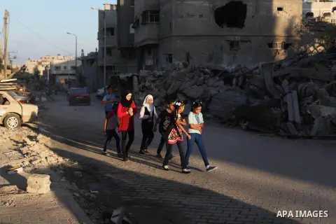 Palestinian students walk past houses that witnesses said were destroyed by the Israeli offensive, as they make their way to school on the first day of the new school year in the east of Gaza City September 14, 2014. An...