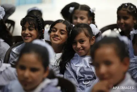 Palestinian students pose for a photograph during the visit of Pierre Krahenbuhl, United Nations Relief and Works Agency (UNRWA) Commissioner-Genera at a United Nations-run school on the first day of a new school year in...