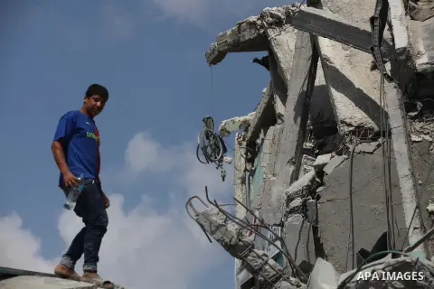 A Palestinian man stands on the rubbles of El-Wafa hospital, which witnesses said was destroyed during a seven-week Israeli offensive, in the east of Gaza City September 15, 2014. An open-ended ceasefire between Israel a...