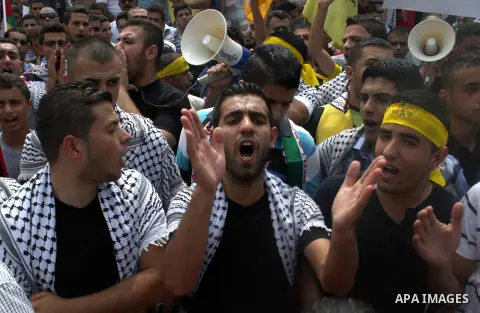 Palestinian supporters of Fatah movement shout slogans during a protest marking the 48th anniversary of the Sabra and Shatila massacre in 1982, in the West Bank city of Nablus, September 16, 2014. The Sabra and Shatila m...