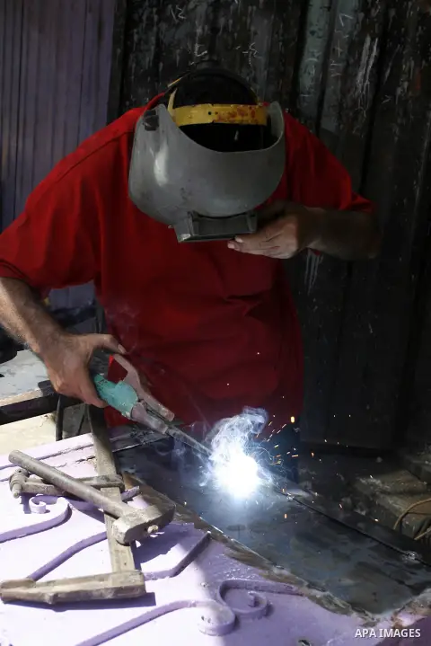 A Palestinian blacksmith works at his workshop in Rafah in the southern Gaza Strip on Sept. 17, 2014. An open-ended ceasefire between Israel and Hamas-led Gaza militants, mediated by Egypt, took effect on August 26 after...