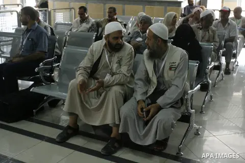 Palestinians Muslim pilgrims wait at the Rafah crossing between Egypt and the southern Gaza Strip, on Sept. 18, 2014, before leaving for the annual hajj pilgrimage to the holy city of Mecca. Hundreds of Palestinian pilgr...
