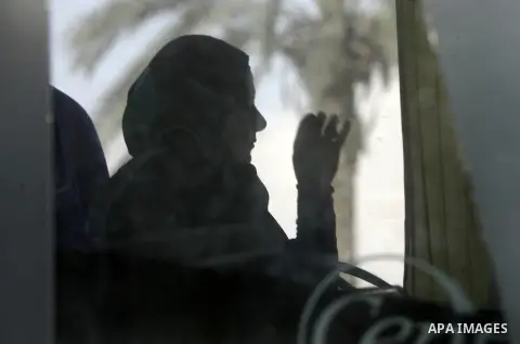 Palestinians Muslim pilgrims wave as they sit in a bus before leaving the Rafah border crossing between Egypt and the southern Gaza Strip, on Sept. 18, 2014, before leaving for the annual hajj pilgrimage to the holy city...
