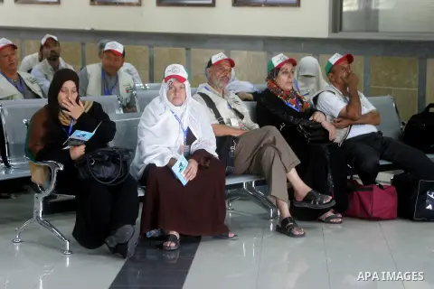 Palestinians Muslim pilgrims wait at the Rafah crossing between Egypt and the southern Gaza Strip, on Sept. 18, 2014, before leaving for the annual hajj pilgrimage to the holy city of Mecca. Hundreds of Palestinian pilgr...
