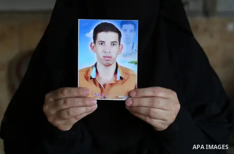 Palestinian Soad al-Jorf, 36, holds a picture of her son Hussein al-Jorf, 19, in her house which was hit by Israeli shelling during the war, in Khan Yunis town in the southern Gaza Strip, on September 18, 2014. Hussein a...