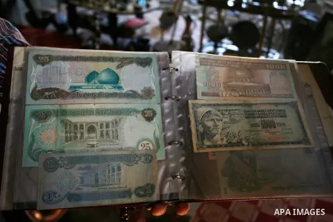 Jamal Abu Elian, 50, a Palestinian man displays old banknotes at his museum, in Khan Younis in the southern Gaza Strip, September 16, 2014. Israeli army destroyed the museum during the offensive on Gaza strip and stole s...