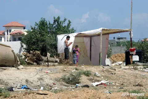 Palestinian girls play in a tent outside their destroyed house in the town of Khan Younis in the southern Gaza Strip, Sep. 22, 2014. Gazans who endured more than 50 days of devastating Israeli bombardment are now eager t...