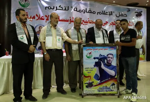 Palestinians attend a ceremony to honor the relatives of the media members who were killed in the Israeli offensive on Sep. 22, 2014. An open-ended ceasefire between Israel and Hamas-led Gaza militants, mediated by Egypt...