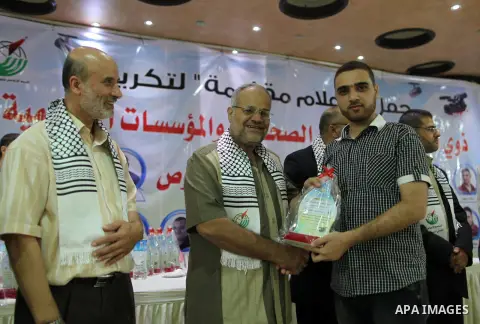 Palestinians attend a ceremony to honor the relatives of the media members who were killed in the Israeli offensive on Sep. 22, 2014. An open-ended ceasefire between Israel and Hamas-led Gaza militants, mediated by Egypt...