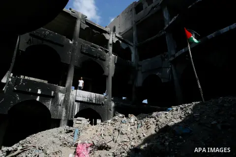 A Palestinian man stand in the heavily damaged commercial center which was destroyed by Israeli strikes during the summer's fierce offensive, in Rafah in the southern Gaza Strip September 23, 2014. Gazans who endured mor...