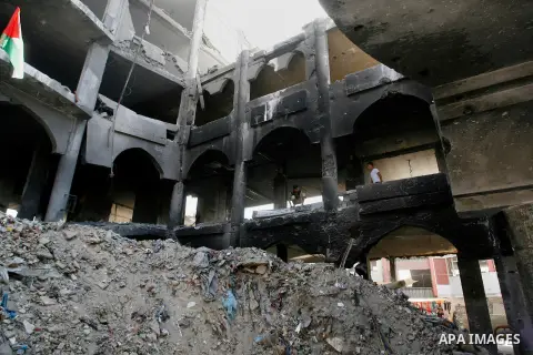 Palestinians inspect the heavily damaged commercial center which was destroyed by Israeli strikes during the summer's fierce offensive, in Rafah in the southern Gaza Strip September 23, 2014. Gazans who endured more than...