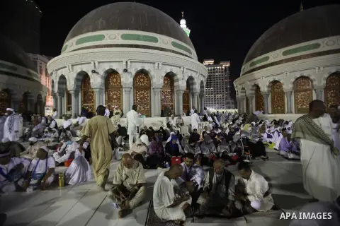Muslim pilgrims walk outside the Grand Mosque during the annual Hajj in Mecca, Saudi Arabia, Sept. 23, 2014. About 160 countries converge annually on the Islamic cities of Mecca and Medina in western Saudi Arabia for the...