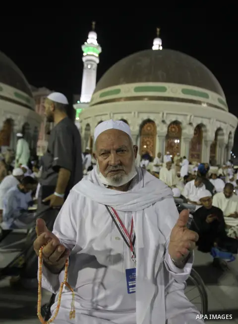 Muslim pilgrims walk outside the Grand Mosque during the annual Hajj in Mecca, Saudi Arabia, Sept. 23, 2014. About 160 countries converge annually on the Islamic cities of Mecca and Medina in western Saudi Arabia for the...