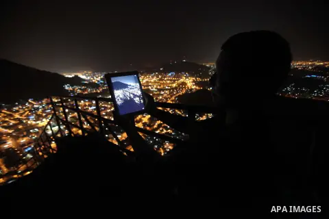 A Muslim pilgrim takes a pictures for Mount Al-Noor during the annual haj pilgrimage in Mecca, on September 29, 2014, Mount Al-Noor houses Ghar-E-Hira or Hira cave, where Prophet Mohammad is said to have spent a great de...