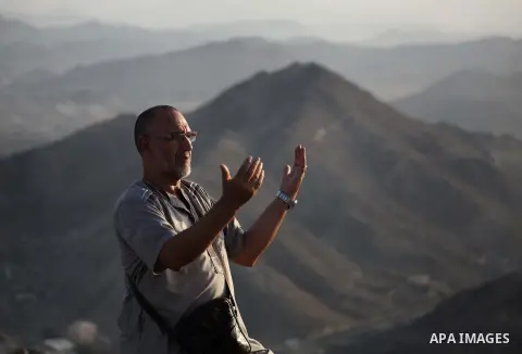 A Muslim pilgrim prays at Mount Al-Noor during the annual haj pilgrimage in Mecca, on September 29, 2014, Mount Al-Noor houses Ghar-E-Hira or Hira cave, where Prophet Mohammad is said to have spent a great deal of time i...