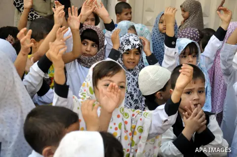 Palestinian children gather around a makeshift cube representing the holy Kaaba in Gaza city, on Sept. 30, 2014, as part of training children how to perform Hajj pilgrimage. Muslims from around the world flood Saudi city...