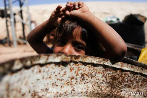 A Palestinian Bedouin boy plays at his family's dwellings, in the West Bank village of Al-Eizariya, near east of Jerusalem, on Septemper 30, 2014. Israel's Civil Administration in the West Bank is advancing a plan to exp...
