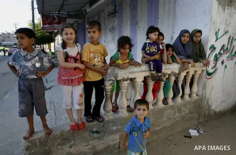 Palestinian children watch a cattle as Muslims prepare for the upcoming Eid al-Adha feast, in Rafah in the southern Gaza Strip, Oct. 3, 2014. Muslims around the world prepared to celebrate Eid Al-Adha on Oct. 4, by slaug...