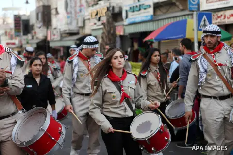 A troop of scouts play drums in the West Bank city of Ramallah during a street festival on October 3, 2014, on the eve of the Muslim of Eid al-Adha or Feast of the Sacrifice, which marks the end of the annual pilgrimage...