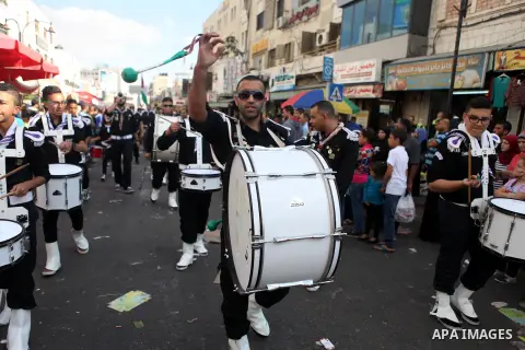 A troop of scouts play drums in the West Bank city of Ramallah during a street festival on October 3, 2014, on the eve of the Muslim of Eid al-Adha or Feast of the Sacrifice, which marks the end of the annual pilgrimage...