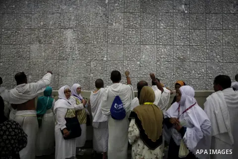 Muslim pilgrims cast stones at a pillar, symbolizing the stoning of Satan, in a ritual called "Jamarat," a rite of the annual hajj, in Mina near the holy city of Mecca on October 04, 2014. The pilgrims perform a series o...