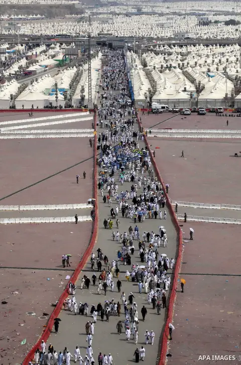 Muslim pilgrims walk to cast stones at a pillar, symbolizing the stoning of Satan, in a ritual called "Jamarat," a rite of the annual hajj, in Mina near the holy city of Mecca on October 05, 2014. The pilgrims perform a...