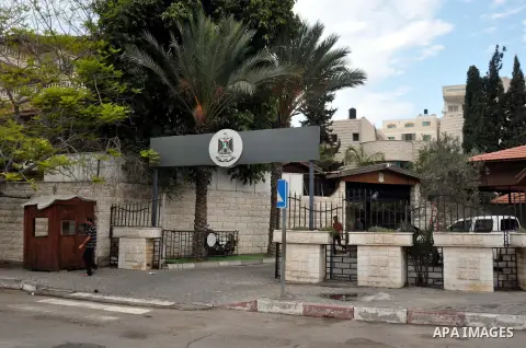 A man walks in front of the house of President Mahmoud Abbas, which turned to the headquarters of the Palestinian Cabinet, in Gaza city on October 8, 2014. The Palestinian unity government, which took the oath of office...