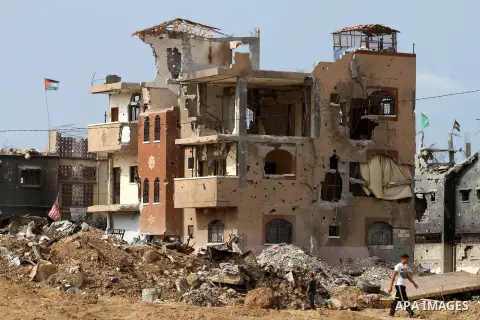 A Palestinian man walks next to the destroyed homes houses and buildings that were destroyed during the devastating 50-day war between Israel and Hamas at Al-Shojae'ya neighborhood east of Gaza City on October 11, 2014....