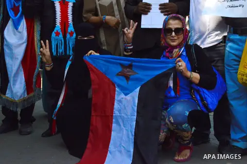 Members of Southern Yemeni community in Egypt hold their national flags as they protest outside the Arab league headquarters demanding that the formerly independent South secede as they celebrated the anniversary of the...