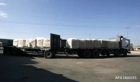 Trucks loaded with bags of cement enter the Gaza Strip from Israel through the Kerem Shalom crossing, in Rafah in southern Gaza on October 14, 2014. International donors pledged about $5.4 billion in aid to the devastate...