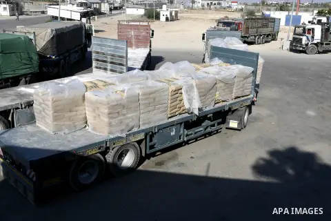 Trucks loaded with bags of cement enter the Gaza Strip from Israel through the Kerem Shalom crossing, in Rafah in southern Gaza on October 14, 2014. International donors pledged about $5.4 billion in aid to the devastate...