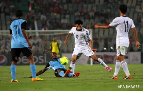 Egyptian players compete against with Botswana players during the qualifying match of 2015 Africa Cup soccer match, in Cairo, capital of Egypt, on Oct. 15, 2014. Egypt won the match with 2-0. Photo by Amr Sayed