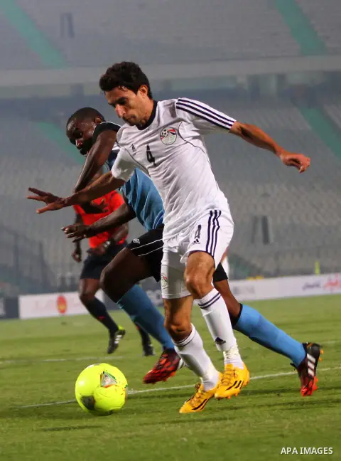 Egyptian players compete against with Botswana players during the qualifying match of 2015 Africa Cup soccer match, in Cairo, capital of Egypt, on Oct. 15, 2014. Egypt won the match with 2-0. Photo by Amr Sayed