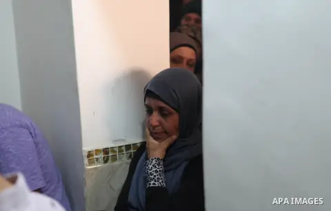 Relatives of 13-year old Palestinian teenager Bahaa Samir Badir mourn over his body during his funeral procession in the West Bank village of Beit Laqiya on October 17, 2014. Badir died after being shot in the chest by I...