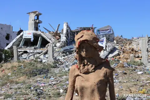 Statues by Palestinian artist Eyad Sabbah,40, stand amidst the rubble of buildings destroyed during the 50 days of conflict between Israel and Hamas last summer, in the Shejaiya neighborhood of Gaza City on October 21, 2...