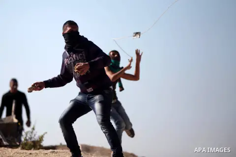 Palestinian protesters throw stones at Israeli soldiers during a demonstration against Israeli restrictions around the al-Aqsa mosque in Jerusalem, in Jalazoun refugee camp near the West Bank town of Ramallah on October...