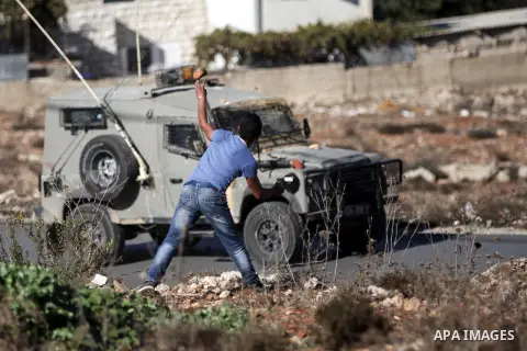 Palestinian protesters throw stones at Israeli soldiers during a demonstration against Israeli restrictions around the al-Aqsa mosque in Jerusalem, in Jalazoun refugee camp near the West Bank town of Ramallah on October...