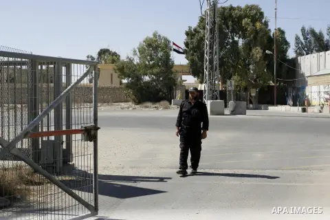 A Palestinian security officer walks past the gate under Egyptian control at the Rafah border crossing with Egypt in the southern Gaza Strip October 25, 2014. The decision was taken to close the Rafah crossing into the G...