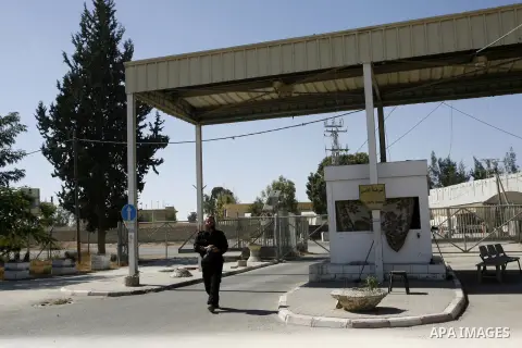 A Palestinian security officer walks past the gate under Egyptian control at the Rafah border crossing with Egypt in the southern Gaza Strip October 25, 2014. The decision was taken to close the Rafah crossing into the G...
