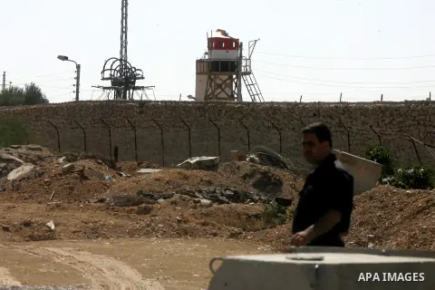 A Palestinian security officer stands near the gate under Egyptian control at the Rafah border crossing with Egypt in the southern Gaza Strip October 25, 2014. The decision was taken to close the Rafah crossing into the...