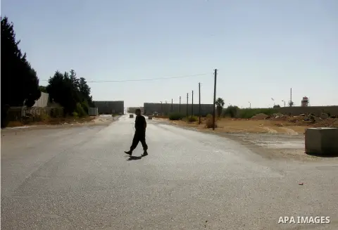 A Palestinian security officer walks past the gate under Egyptian control at the Rafah border crossing with Egypt in the southern Gaza Strip October 25, 2014. The decision was taken to close the Rafah crossing into the G...
