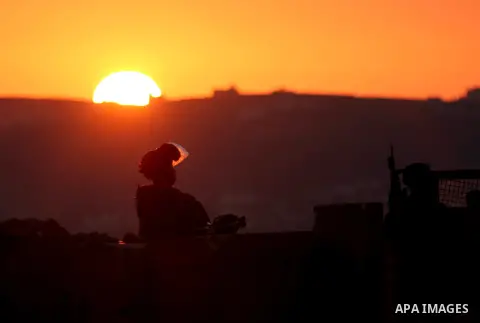 Palestinian youths from the Selwan Village throw stones as they clash with Israeli security forces, near Ramallah in West Bank, on October 25, 2014. Photo by Shadi Hatem