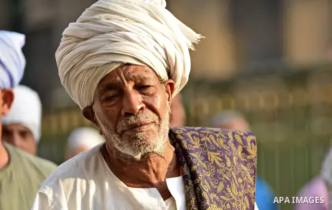 A member of Egyptian sufi muslim group performs as they parade the street during a ritual to commemorate the Hijri New Year, also known as Islamic New Year, in Cairo on October 26, 2014. The Islamic year lasts for about...