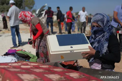 Palestinian Bedouins remove debris as they look for their belongings amongst the rubble of their house that was demolished by Israeli bulldozers near the Jewish settlement of Karmel, in the village of Om al-Khair near th...