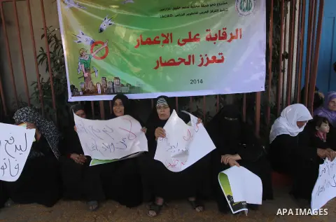 Palestinians hold banners during a protest to demand their rights and the reconstruction of homes destroyed in front of the headquarter United Nation "UNSCO", in Gaza city, on Oct. 28, 2014. Photo by Mohammed Asad