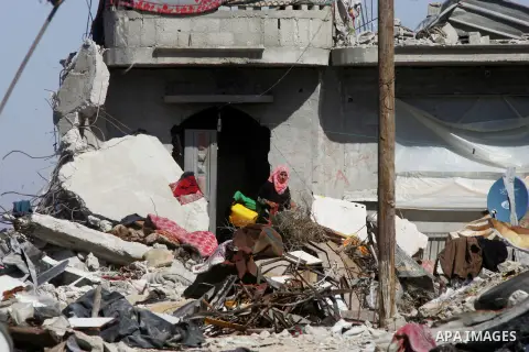 A Palestinian woman stands outside her a destroyed house which witnesses said was destroyed by Israeli forces during the most recent conflict between Israel and Hamas, in Khuzaa in the east of Khan Younis, in the souther...