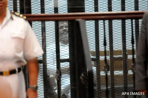 Egypt's deposed Islamist president Mohamed Morsi sits inside the defendant's cage during his trial in Cairo on October 29, 2014. Ousted president Mohamed Morsi’s 'Prison Break' trial which took place Wednesday has been p...