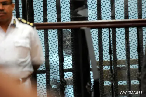 Egypt's deposed Islamist president Mohamed Morsi sits inside the defendant's cage during his trial in Cairo on October 29, 2014. Ousted president Mohamed Morsi’s 'Prison Break' trial which took place Wednesday has been p...