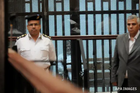 Egypt's deposed Islamist president Mohamed Morsi sits inside the defendant's cage during his trial in Cairo on October 29, 2014. Ousted president Mohamed Morsi’s 'Prison Break' trial which took place Wednesday has been p...
