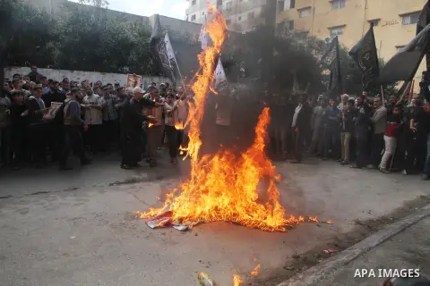 Palestinians burn a U.S flag and an Israeli flag during an anti-Israel rally organised by the Islamic Jihad movement over the entry restrictions to the al-Aqsa mosque, in Gaza City October 31, 2014. Muslim men over 50 pr...
